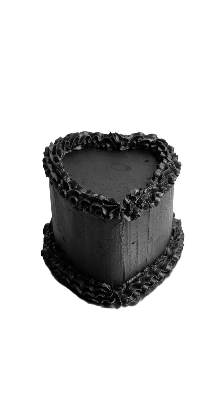 Black heart-shaped cake with ruffled buttercream piping